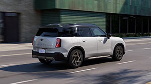 Insured Warranty. MINI Countryman driving down the road.